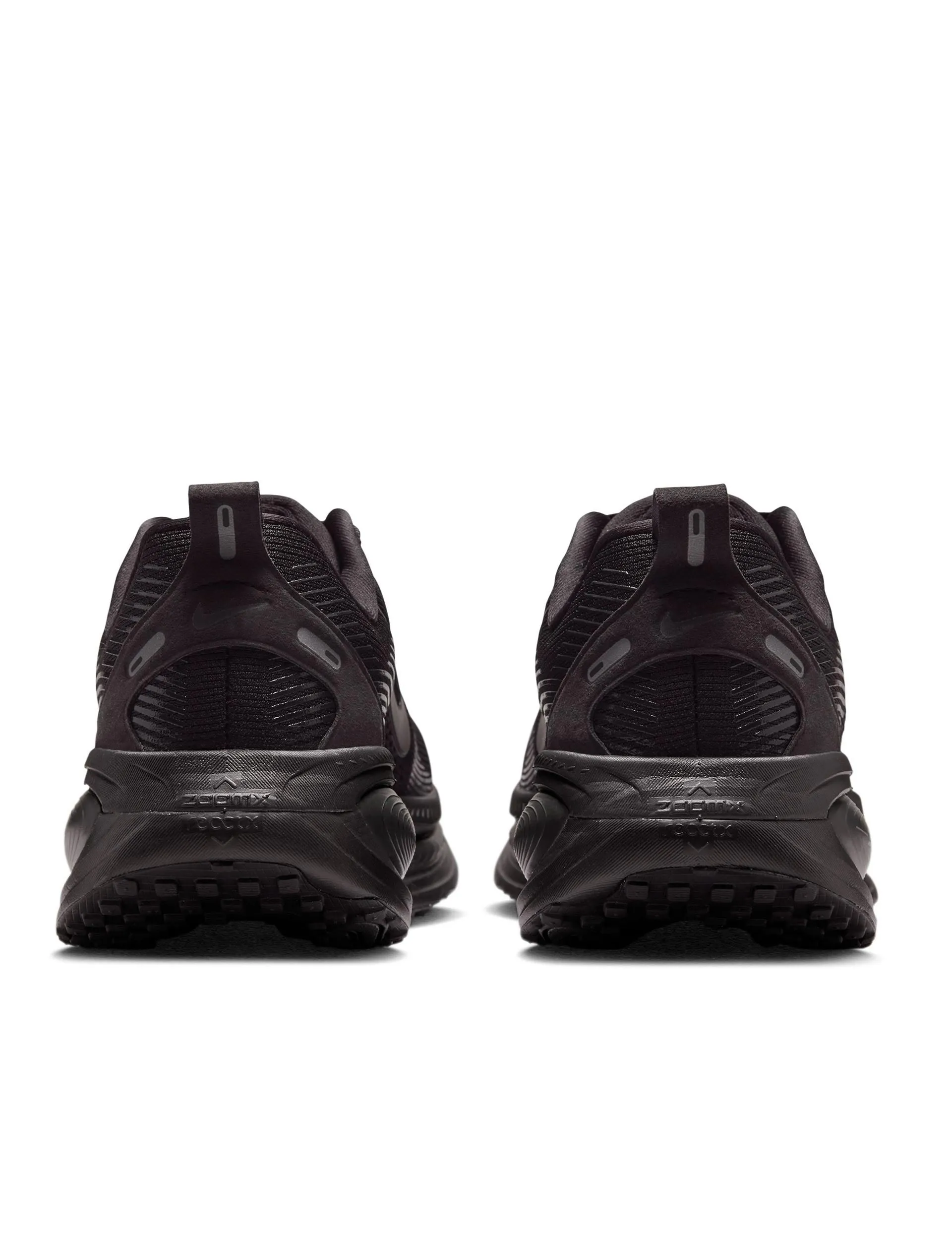 Vomero 18 Running Shoes - Black/Dark Smoke Grey/Light Smoke Grey running with a reflector